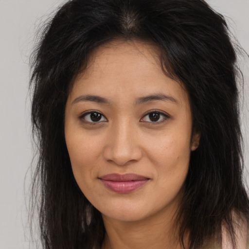 Joyful asian young-adult female with long  brown hair and brown eyes