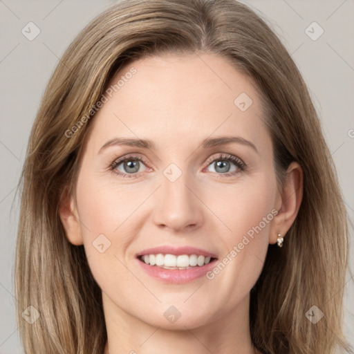 Joyful white young-adult female with long  brown hair and grey eyes