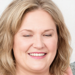 Joyful white adult female with medium  brown hair and blue eyes