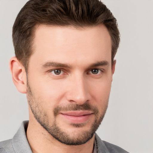 Joyful white young-adult male with short  brown hair and brown eyes