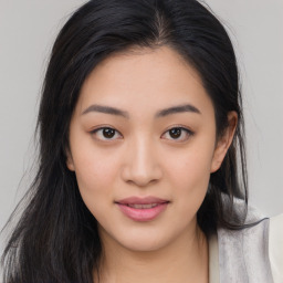 Joyful asian young-adult female with long  brown hair and brown eyes