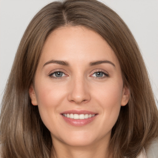 Joyful white young-adult female with long  brown hair and grey eyes