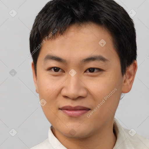 Joyful asian young-adult male with short  brown hair and brown eyes
