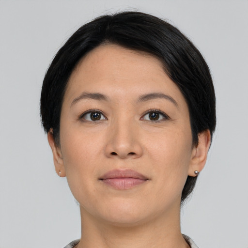 Joyful asian young-adult female with short  black hair and brown eyes