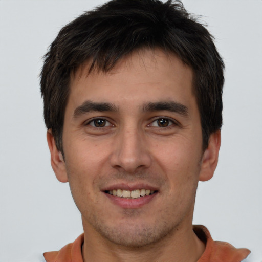 Joyful white young-adult male with short  brown hair and brown eyes