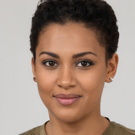 Joyful latino young-adult female with short  brown hair and brown eyes