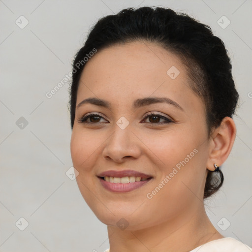 Joyful latino young-adult female with short  brown hair and brown eyes