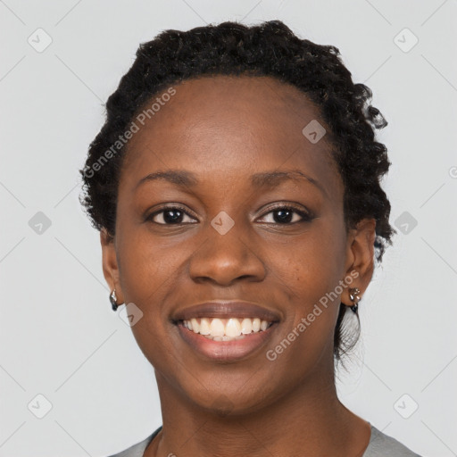 Joyful black young-adult female with short  black hair and brown eyes