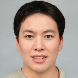 Joyful asian young-adult male with short  brown hair and brown eyes