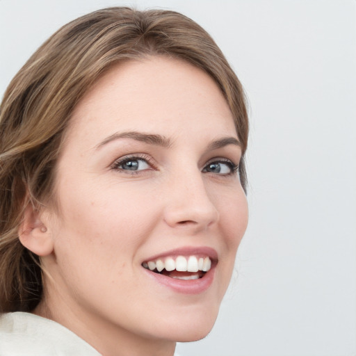 Joyful white young-adult female with medium  brown hair and green eyes