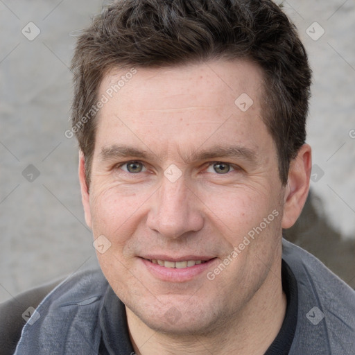 Joyful white adult male with short  brown hair and grey eyes