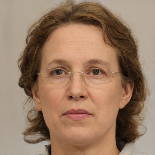 Joyful white adult female with medium  brown hair and green eyes