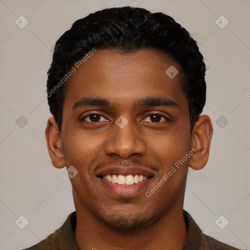 Joyful black young-adult male with short  black hair and brown eyes