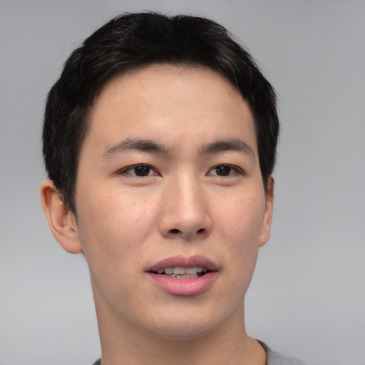 Joyful asian young-adult male with short  brown hair and brown eyes