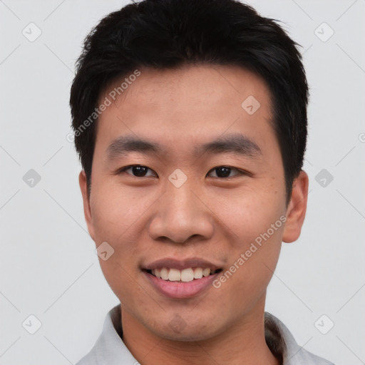 Joyful asian young-adult male with short  black hair and brown eyes