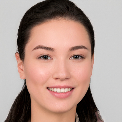 Joyful white young-adult female with long  brown hair and brown eyes