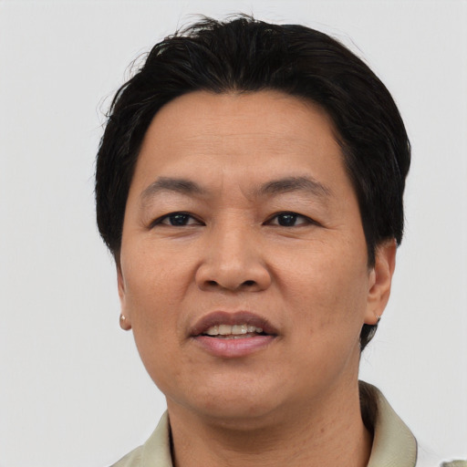 Joyful asian adult male with short  brown hair and brown eyes