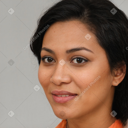 Joyful latino young-adult female with medium  brown hair and brown eyes