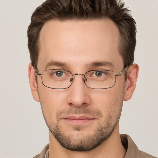 Joyful white young-adult male with short  brown hair and grey eyes