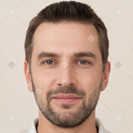 Joyful white young-adult male with short  brown hair and brown eyes