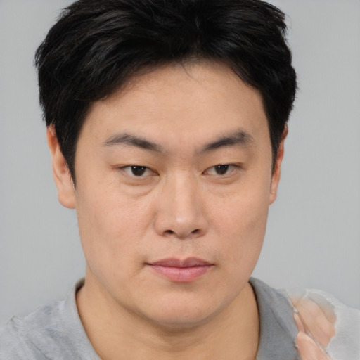 Neutral asian young-adult male with short  brown hair and brown eyes