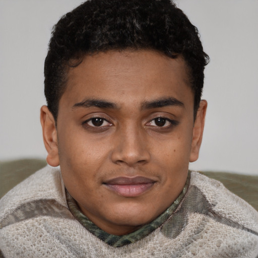 Joyful black young-adult male with short  brown hair and brown eyes