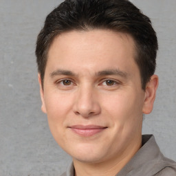 Joyful white adult male with short  brown hair and brown eyes