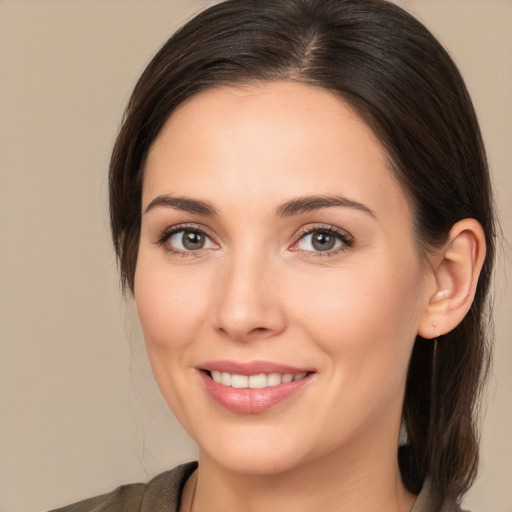 Joyful white young-adult female with medium  brown hair and brown eyes