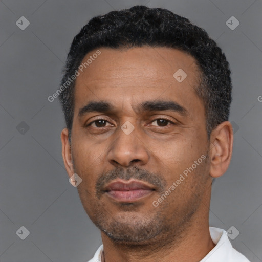 Neutral latino adult male with short  black hair and brown eyes