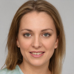 Joyful white young-adult female with medium  brown hair and green eyes