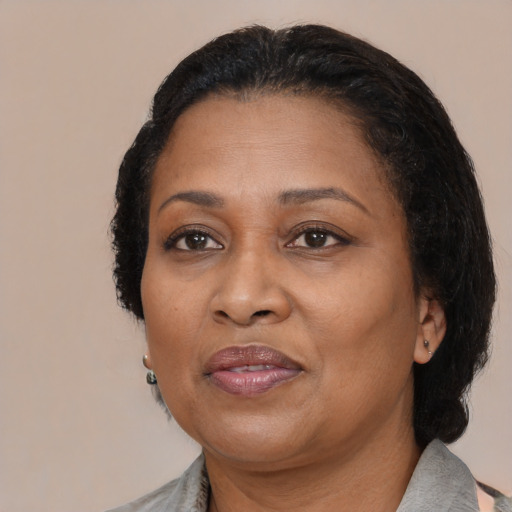 Joyful black adult female with medium  black hair and brown eyes