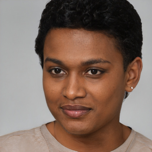 Joyful black young-adult female with short  black hair and brown eyes
