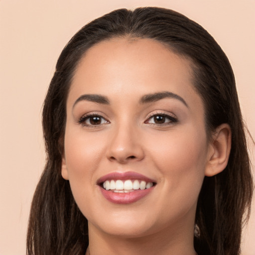 Joyful white young-adult female with long  brown hair and brown eyes