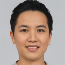 Joyful asian young-adult male with short  black hair and brown eyes