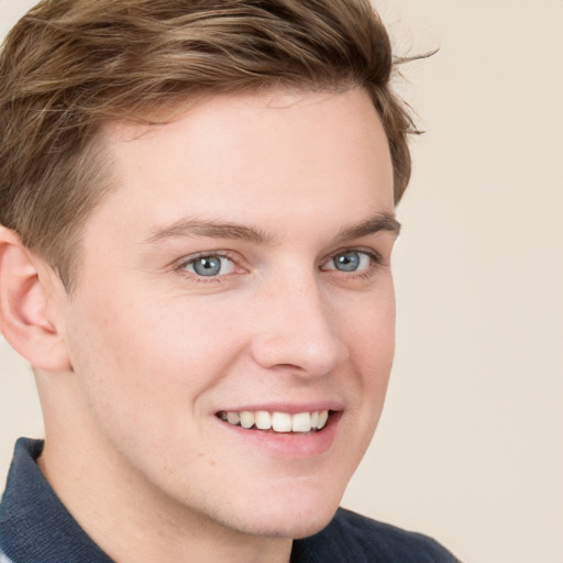 Joyful white young-adult male with short  brown hair and blue eyes