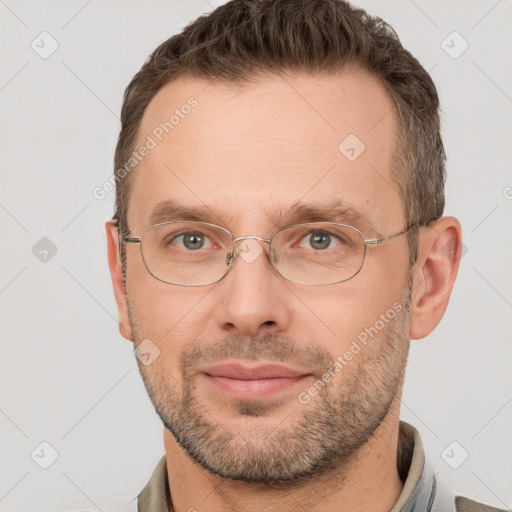 Joyful white adult male with short  brown hair and grey eyes