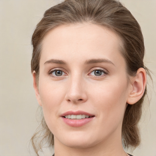 Joyful white young-adult female with medium  brown hair and green eyes