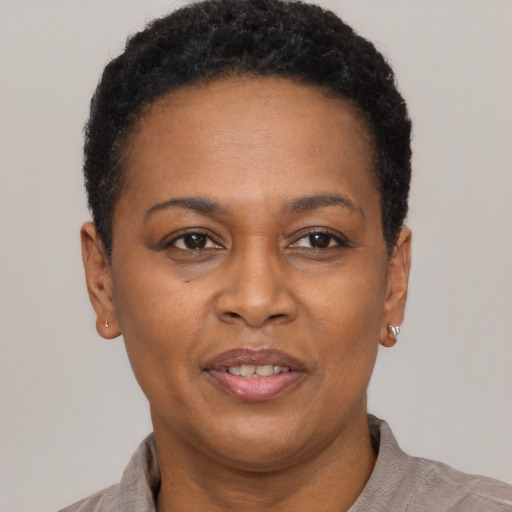 Joyful black adult female with short  black hair and brown eyes