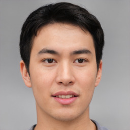 Joyful asian young-adult male with short  brown hair and brown eyes