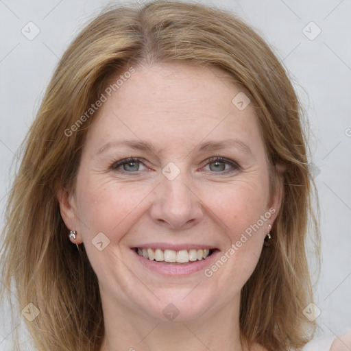 Joyful white adult female with medium  brown hair and grey eyes