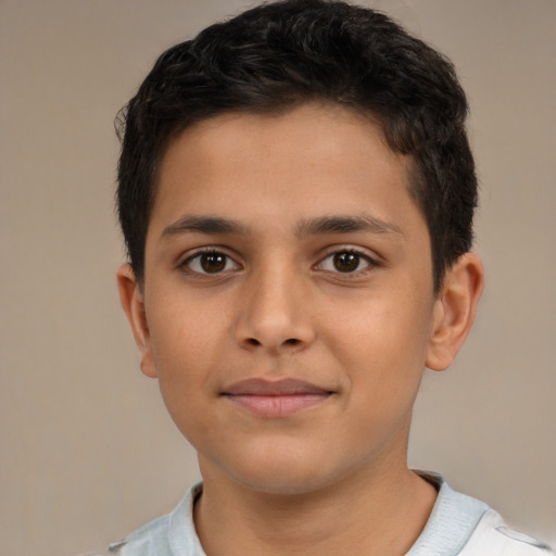 Joyful latino child male with short  brown hair and brown eyes