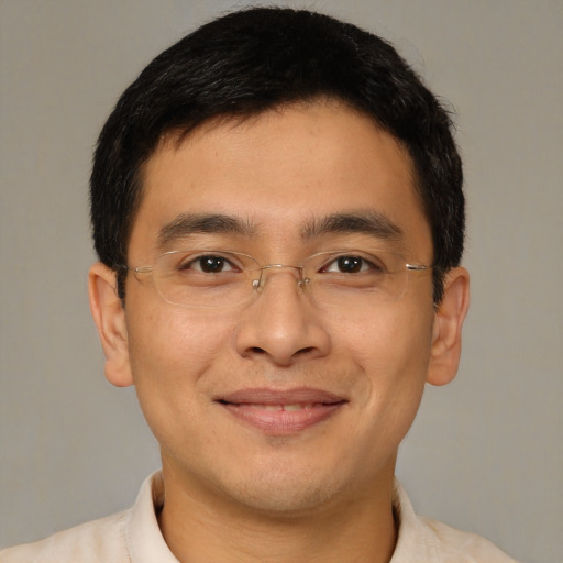 Joyful asian young-adult male with short  brown hair and brown eyes