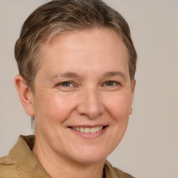 Joyful white adult female with short  brown hair and grey eyes