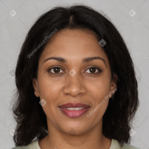 Joyful black adult female with medium  brown hair and brown eyes