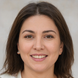 Joyful white young-adult female with medium  brown hair and brown eyes