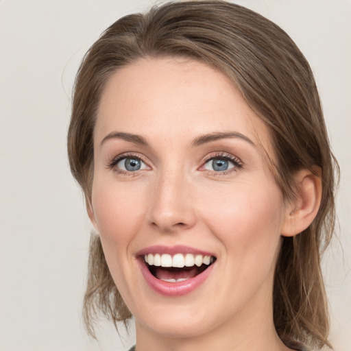 Joyful white young-adult female with medium  brown hair and grey eyes