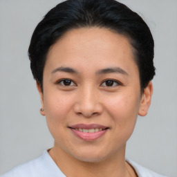 Joyful asian young-adult female with short  black hair and brown eyes