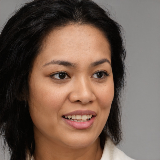 Joyful latino young-adult female with medium  brown hair and brown eyes