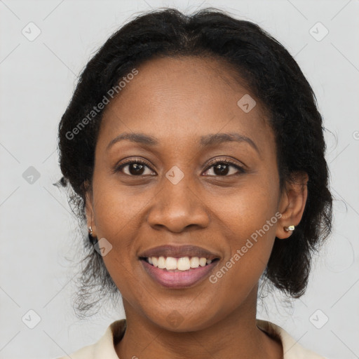 Joyful black adult female with medium  brown hair and brown eyes