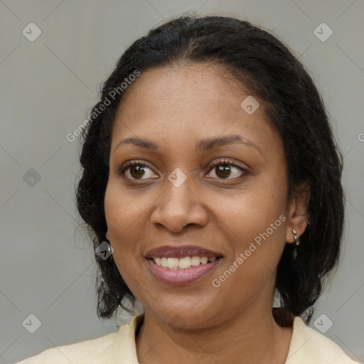 Joyful black adult female with medium  brown hair and brown eyes